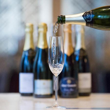 Makati Diamond Residences Макати Экстерьер фото Sparkling wine being poured