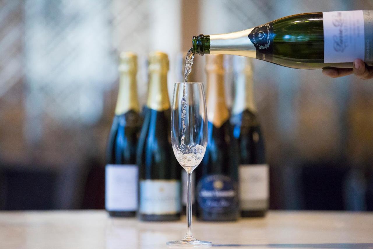 Makati Diamond Residences Макати Экстерьер фото Sparkling wine being poured